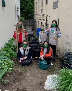 Quincy Girl Scouts pose in Interfaith's alleyway garden