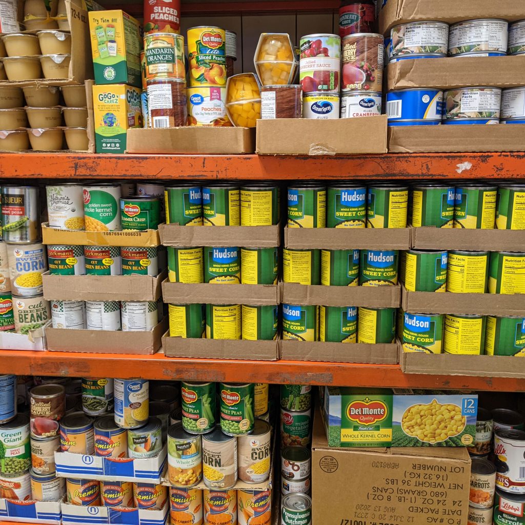 Food pantry shelves replenished with donated canned goods