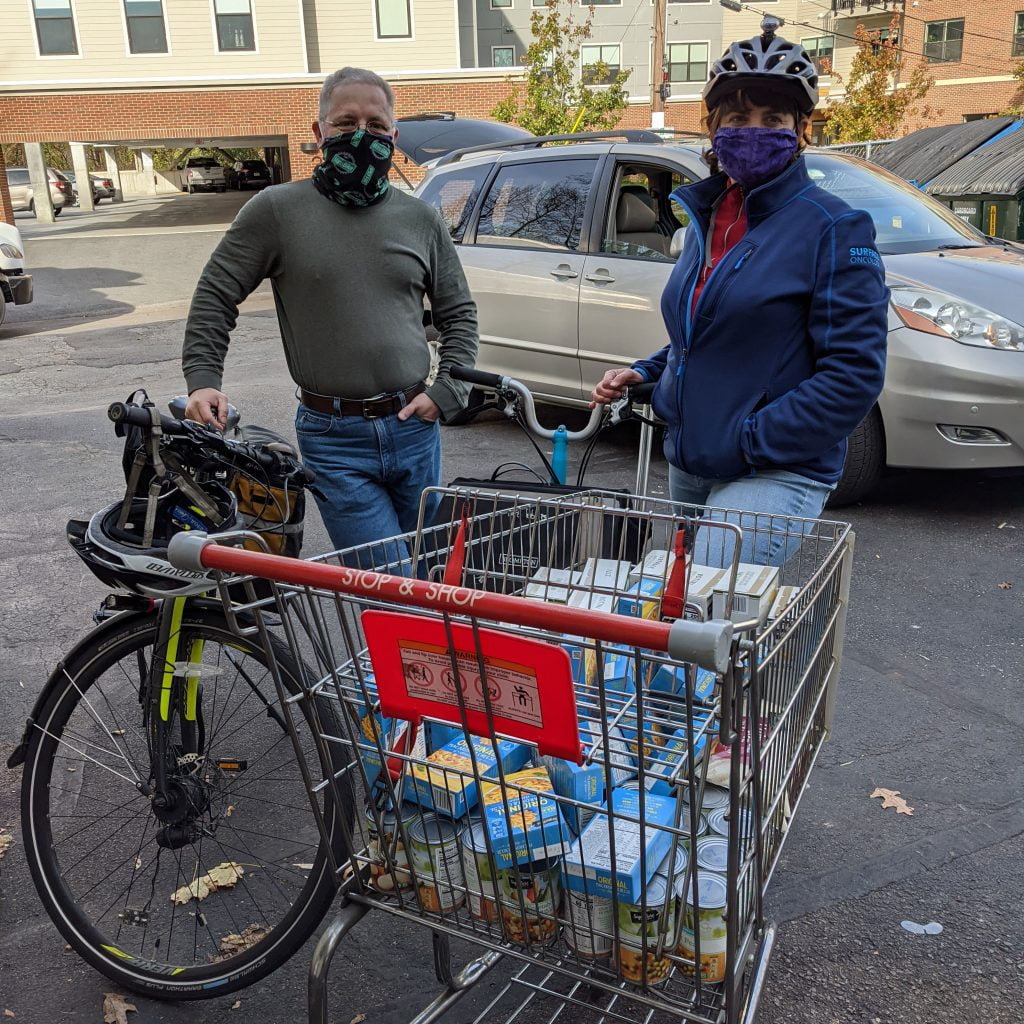 Members of the Quincycles group deliver food donations by bicycle