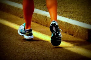 legs and sneakers running down the street