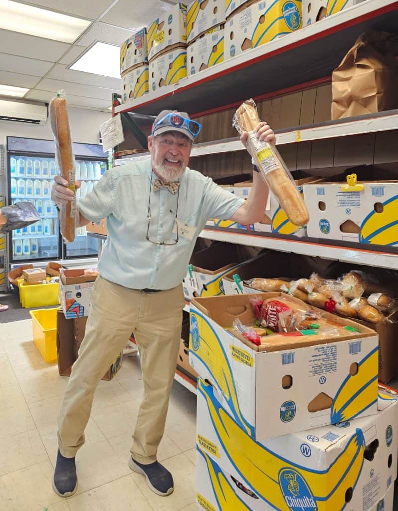 An Interfaith volunteers sorts through boxes of rescued bread.