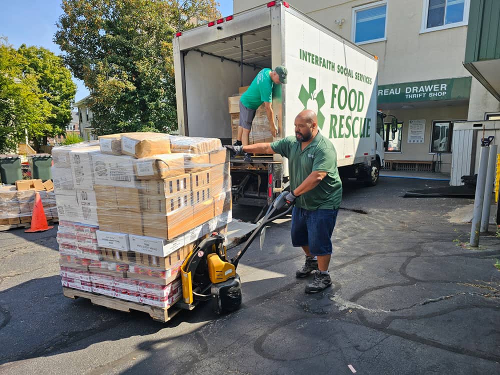 Interfaith Social Services’ Food Rescue Coordinators Geoff Bowen (foreground) and Dritan Spiro assist in recovering more than 8,000 pounds of food each week from local grocery stores and retailers. The rescued food, which otherwise would have ended up in landfills, is redistributed to the organization’s food pantry clients.