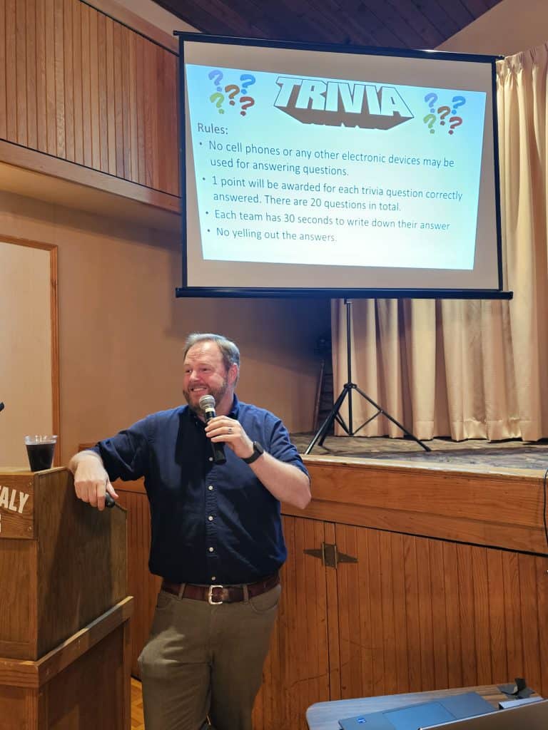 Interfaith's executive director Rick Doane leads trivia at the 2025 Volunteer Appreciation event Aug. 14.