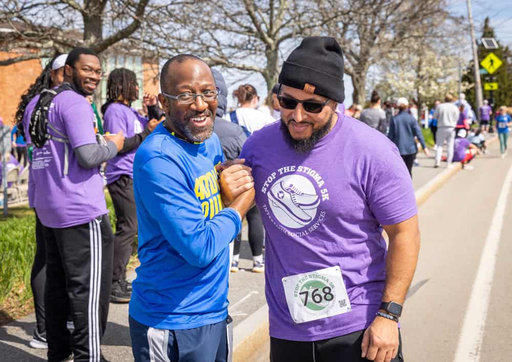 2026 Stop the Stigma 5k participants clasping hands