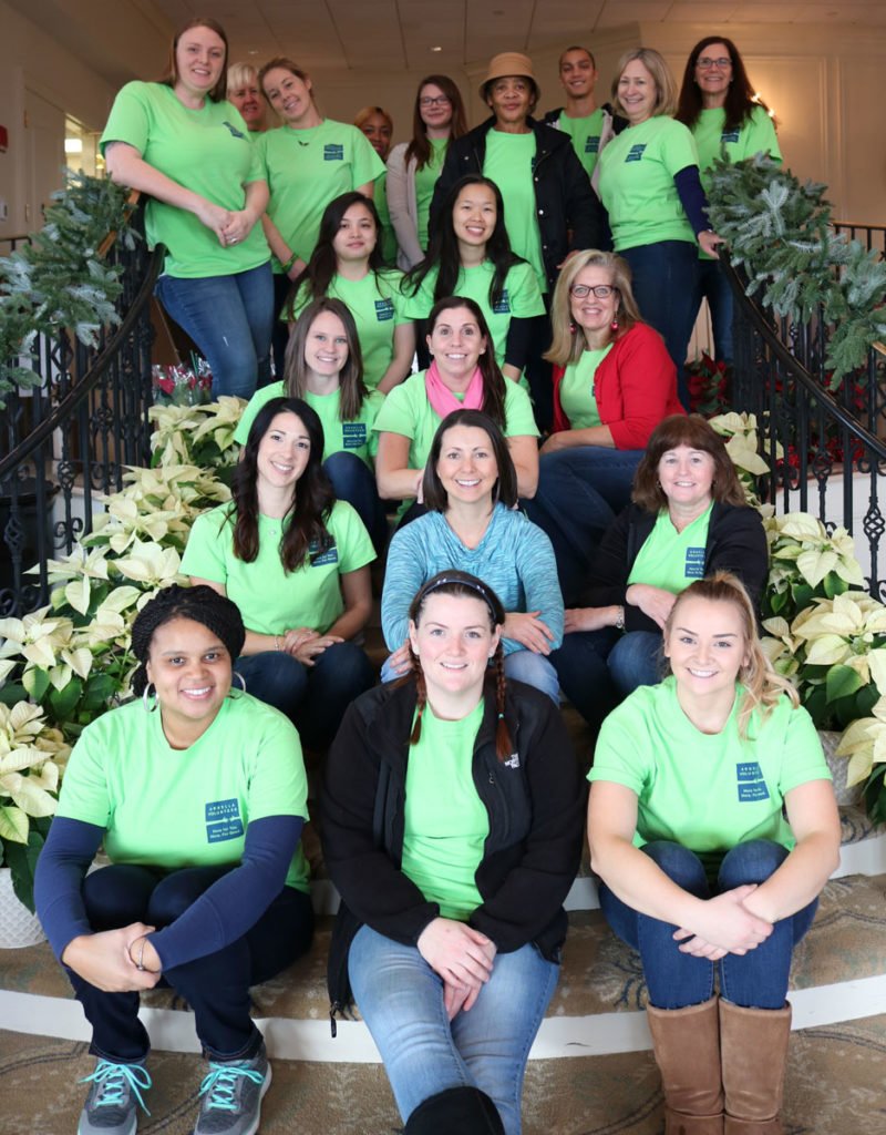 Arbella volunteers (in green shirts) and Paula Daniels, Interfaith's Development Director, on the morning of the event.