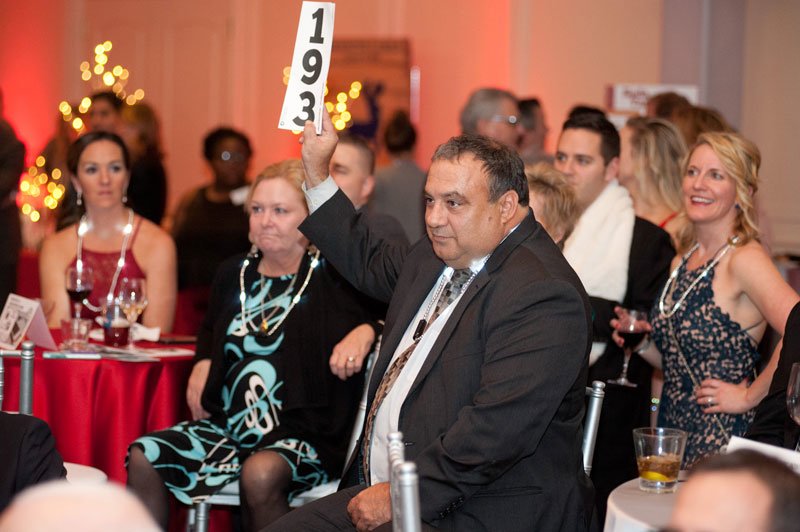 Guest Matt Donnelly raises his paddle during the live auction.