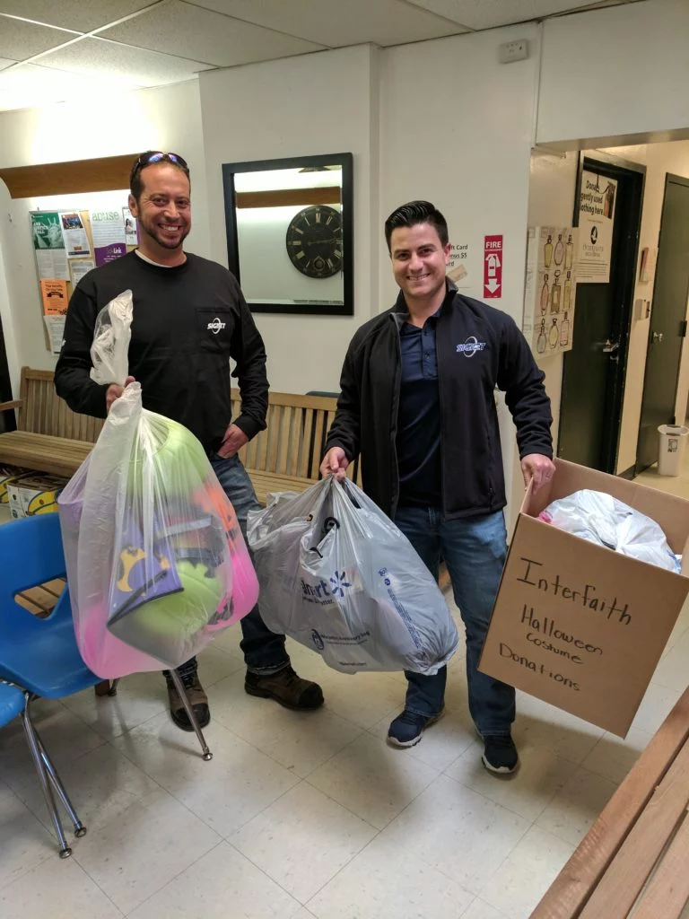 Corporate volunteers from Signet brought in several bags of costumes and treat bags. Photo by Jennifer Sammons.